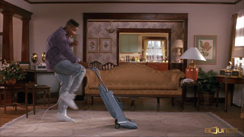 Guy dancing while using a vacuum cleaner