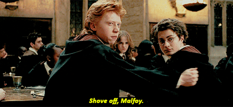 Ron turning Harry around while sitting in the Great Hall