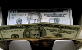 twenty dollar bills flipping through a money counting machine