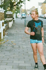 GIF of Simon Pegg wearing short shorts and stretching