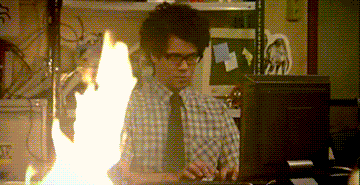 Man typing on computer while next to a desk fire