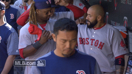 Boston Red Sox Hanley Ramirez helps catcher Sandy Leon stretch his arm