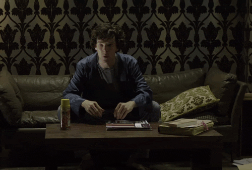 GIF of Sherlock turning over in frustration to ignore people