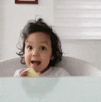 Excited toddler giving a thumbs up
