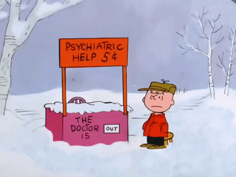 a gif of Lucy van Pelt from the Peanuts cartoon, brushing the snow off her psychiatric help stand and flipping her "the doctor is" sign from "out" to "real in"