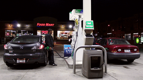 a man loading his car with fuel