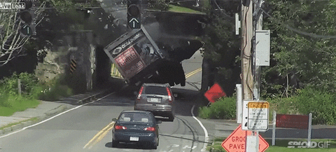 Truck crashing into bridge with two cars behind