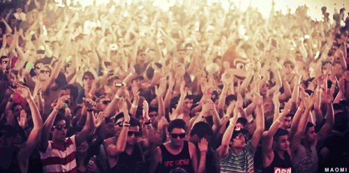 Big crowd clapping their hands at a concert