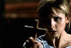 Buffy the Vampire Slayer holding out a cross