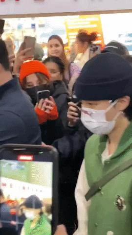 BTS' J-Hope and Jimin surrounded by several fans in PARIS