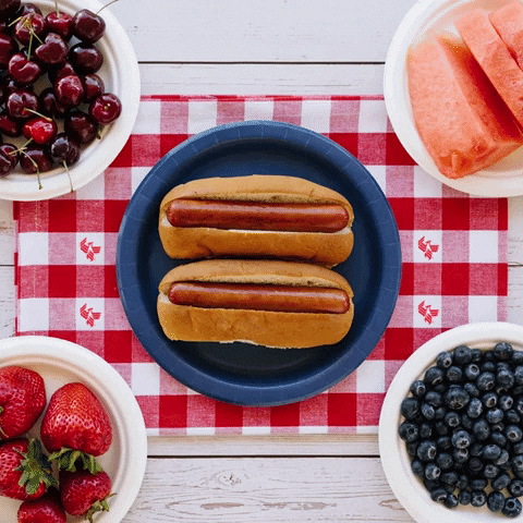 Gif of hotdogs with mustard spelling out Happy Fourth of July