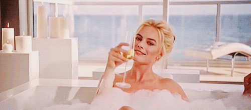 Margot Robbie relaxes in the hot tub with some champagne