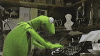 Kermit the Frog typing furiously on a typewriter