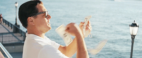 Leonardo DiCaprio in Wolf of Wall Street throwing money into the ocean