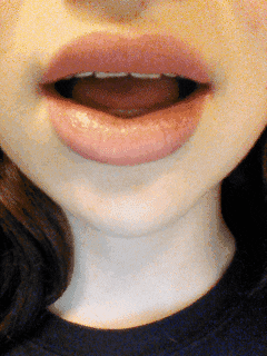 A GIF of a person playfully biting their lip with a mischievous expression, highlighting the versatility of the gesture.