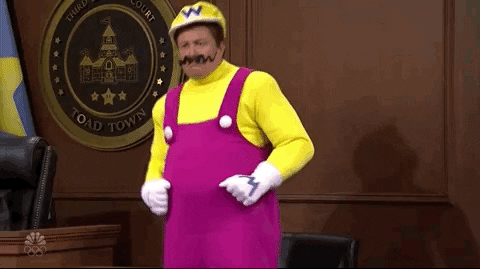 A gif of Elon Musk dressed up as Wario dancing funnily in a court room.