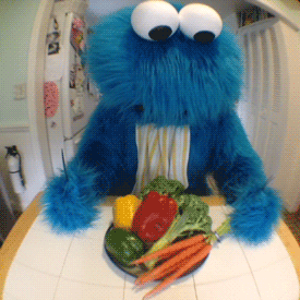 muppet character throwing vegetables off table