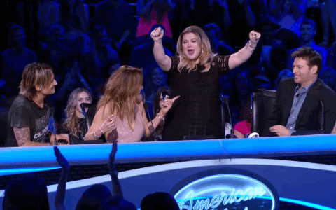 Singer, Kelly Clarkson, dances excitedly on stage