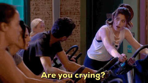 A gif of a group of people in a spin class at the gym