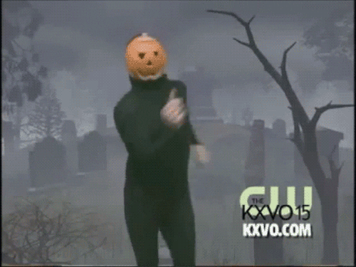 GIF of dancing person, dressed in full black with a pumpkin on their head