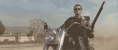 Arnold Schwarzenegger on a motorcycle firing a shotgun in the move The Terminator 
