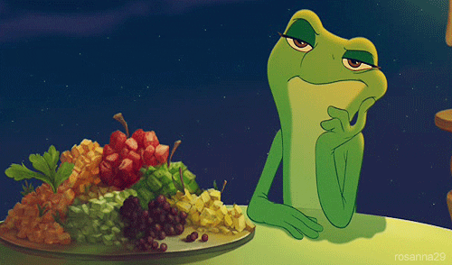 Tiana, the princess from The Princess and the Frog, sitting at a table with a plate of food