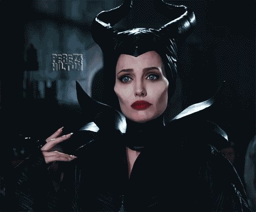 Gif of Maleficent, a thin, white woman with black horns and clothing, blue eyes and red lips, looking downcast, from the movie, Maleficent