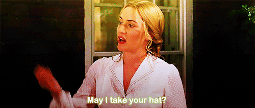 Image description: A gif of a scene from the movie. Sylvia asks Barrie “May I take your hat” when he comes dressed like it’s a fancy dress party.