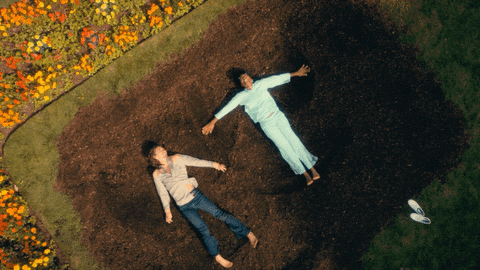 Jill and Klaus (...ish, superhero shenanigans) making dirt angels in the cult's garden
