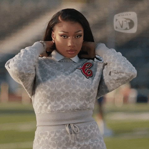 a GIF of Meg the Stallion playing with her straight hair