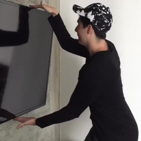 Man Measuring TV With Hands 