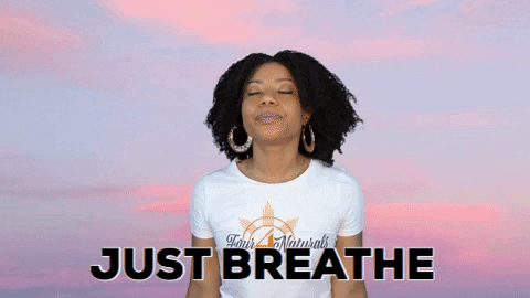 Gif of woman meditating and saying "Just breathe"