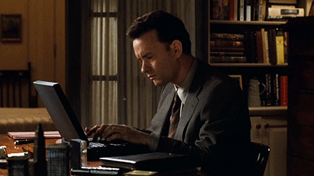 Gif of Tom Hanks in You Got Mail movie typing at his computer, looking frustrated.