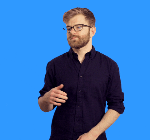 Bearded man in black shirt with glasses gestures with each hand as if to say 