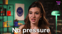 Nervous person smiling under the words 'no pressure'