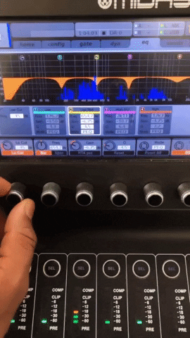 GIF of an audio engineer turning a knob making EQ adjustments.