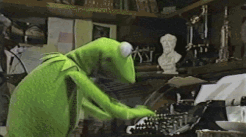 Kermit the Frog blogging on a typewriter.