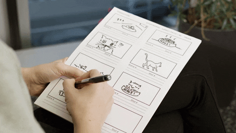 a person drawing on an animation storyboard