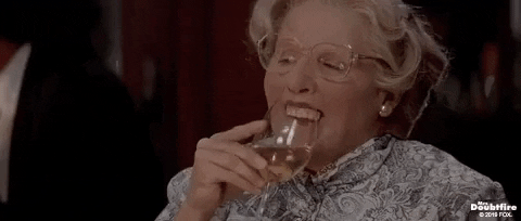 Animated GIF: Mrs Doubtfire spitting her dentures into a wine glass. 