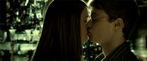 A closeup of Harry and Ginny kissing in the room of requirement. Both have their eyes closed at first, but Ginny opens her eyes and begins to pull away from the kiss.