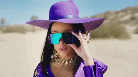 The gif od Doja Cat in a purple hat wearing sunglasses.