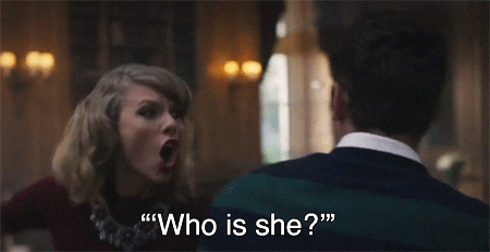 Taylor swift yelling at man dressed in a suit "who is she!?" and pointing jealously