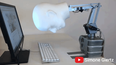 Robot Head Rolling Across Keyboard