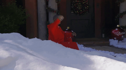Winter Activity: Dad in red sweatshirt throwing snowball at boy in winter onesie
