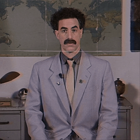Borat levantando os polegares em sinal de afirmação
