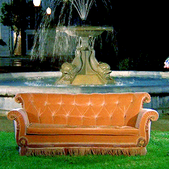 Gif of the cast of "FRIENDS" on the couch in front of a fountain