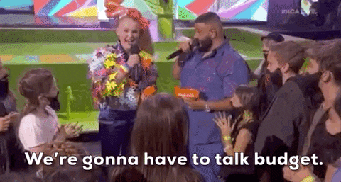 Gif of Jojo Siwa and DJ Khaled during the kids choice award. They are talking about a budget, saying "we're gonna have to talk budget"
