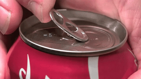 A person opening a can of soda. A person opening a can of soda.