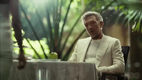 Vincent Cassel in a white suit talking