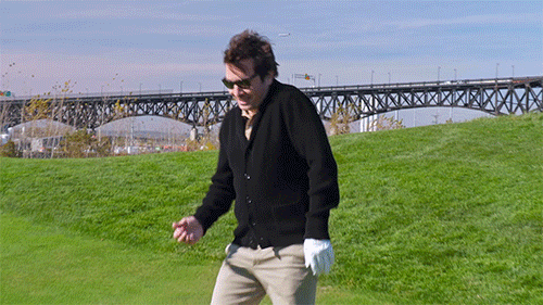 A professional male golfer raising his hand because he won the tournament and there are no more yips